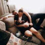 family with baby on couch